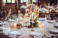 Rustic Wedding Decorations With Flowers And Candles. Banquet Decor. Picture With Soft Focus