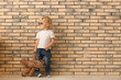 © Pixel-Shot - Portrait of cute little boy with sunglasses and teddy bear near brick wall