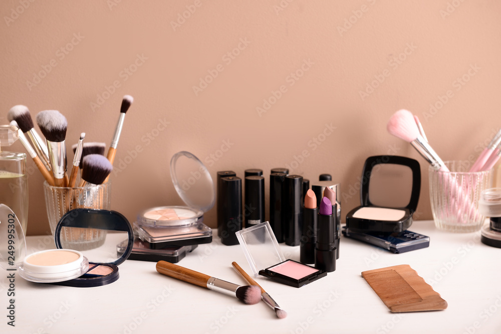 Professional makeup cosmetics with brushes on dressing table