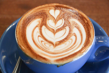 Coffee cup with latte art foam on wood table in coffee shop with copy space.Coffee is one of the most popular beverages.Improve Energy Levels and Burn Fat