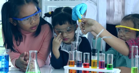close up scene video of science teacher teach asian students in laboratory room, student drop someth
