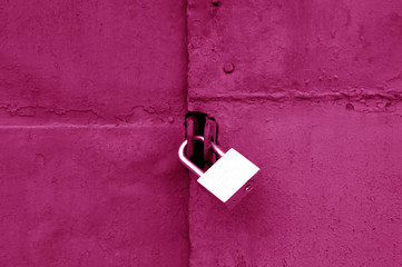 Wall Mural - Old padlock on metal gate in pink color.