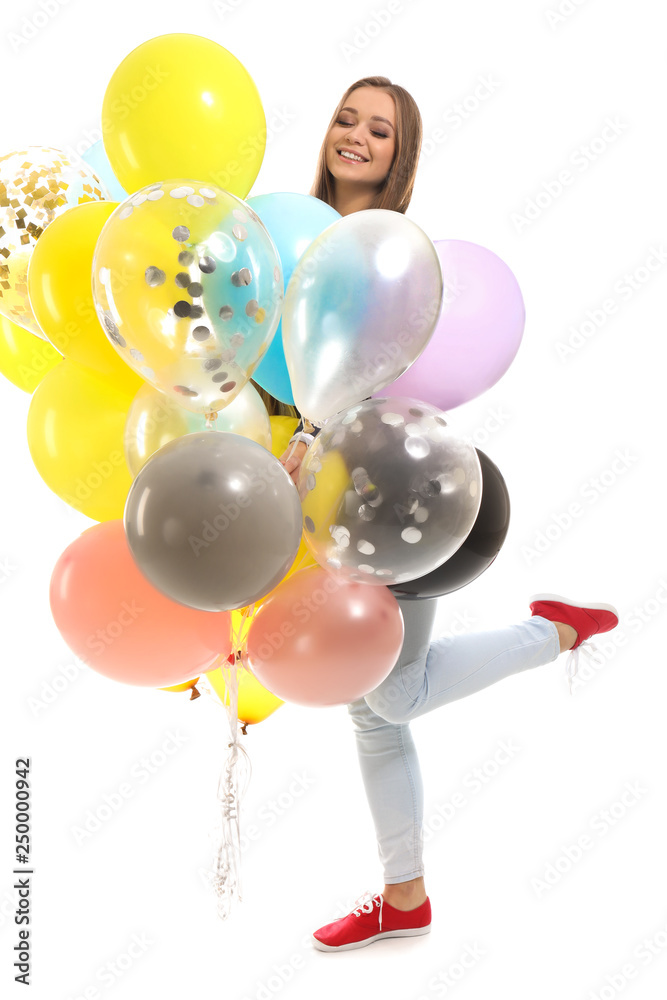 Beautiful young woman with balloons on white background