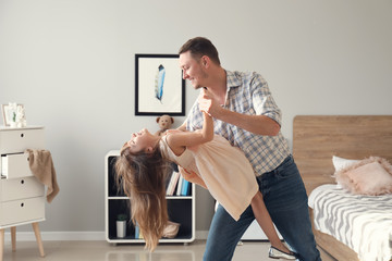 Canvas Print - Father and his cute little daughter dancing at home