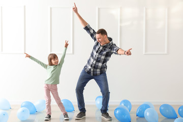 Canvas Print - Father and his cute little daughter dancing in room with balloons