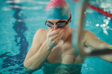 Portrait Of A Fit Swimmer In The Pool At Leisure Center Wear Mask