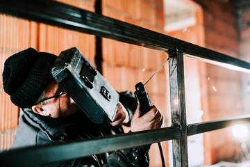 Wall Mural - Middle aged caucasian man welding with professional tools