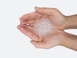 Close up of hand holding silica gel on white background, Desiccant attract moisture for chemical.