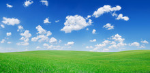 Idyllic View, Green Hills And Blue Sky With White Clouds