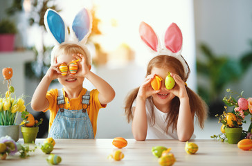 Wall Mural - Happy easter! funny funny children   with ears hare getting ready for  holiday.