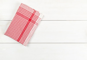 Wall Mural - Red checkered dishcloth on white wooden plank table flat lay top view from above