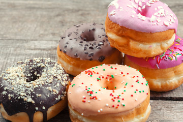 Glazed donuts on wooden background