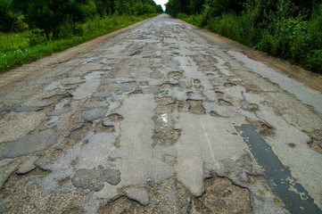 Canvas Print - Bad road cracked and damaged