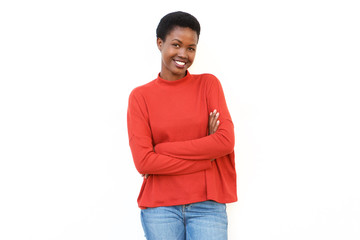 smiling young african woman with arms crossed against white background