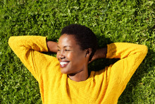 Above Of Happy Young Black Woman Lying On Green Grass