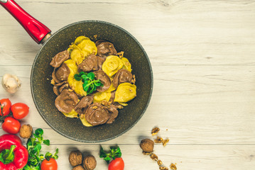 Wall Mural - Cassic ravioli filled with nuts and cheese in a cooking pan.