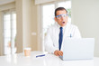 © Krakenimages.com - Middle age scientist man wearing professional glasses working using laptop scared in shock with a surprise face, afraid and excited with fear expression