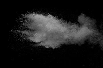 Wall Mural - Explosion of white dust on black background.