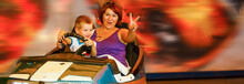 Mother And His Little Son Enjoy The Ride At Attraction Park