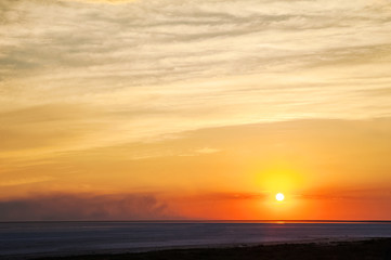 Beautiful natural textural background of the sunset on the lake, river. Salt lake Elton, Russia, sunset on the water