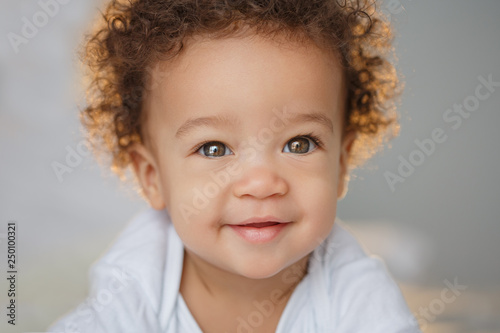 Cute baby with fluffy hair. Pretty boy. Poster Mural XXL