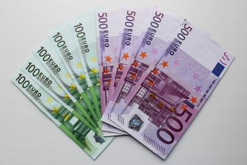 Fan of banknotes 500 and 100 euro on white background