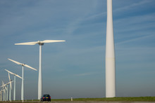 Wind Turbines In A Rural Landscape Along Side A Country Road
