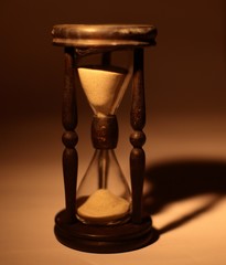 Wall Mural - closeup of hourglass. isolated on blue background.