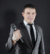 © yurolaitsalbert - young successful businessman with microphone.isolated on black