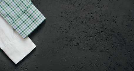 Poster - Cuffs from business shirts on a dark background. Vertical sleeves from shirts in green, blue and white. The concept of fashion and sale of luxury clothes.