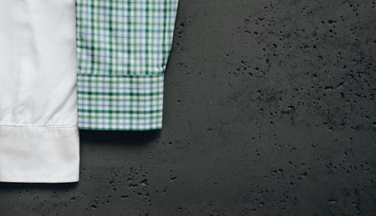 Poster - Cuffs from business shirts on a dark background. Vertical sleeves from shirts in green, blue and white. The concept of fashion and sale of luxury clothes.