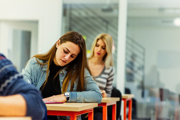 Wall Mural - Stressed college student for exam in classroom