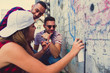 © qunica.com - Friends having fun painting on wall