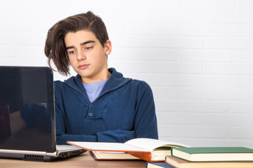 Sticker - young student with computer and books on the desk