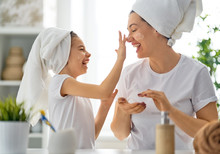 Mother And Daughter Caring For Skin