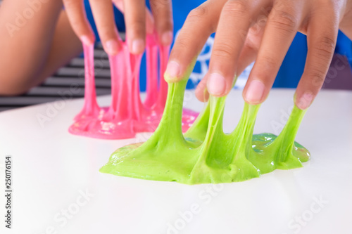 Cuadros en Lienzo Hand Holding Homemade Toy Called Slime, Kids having fun and being creative by science experiment