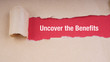 UNCOVER THE BENEFITS text on brown envelope and torn paper. Concept Image