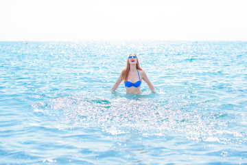 Vacation and summer concept. Redhead girl enjoy the sea and sun. Lady in swimwear at holidays