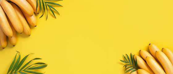 Bright yellow background with bunch of bananas