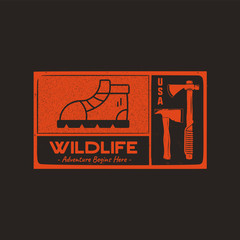 hand drawn travel badge with hiking boot, axes and quote - wildlife adventure begins here. camping e