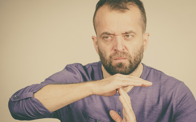 Man showing time stop gesture