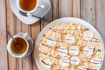 Cake delicious on plate. Bakery, cream dessert cake with tea spot on wooden table