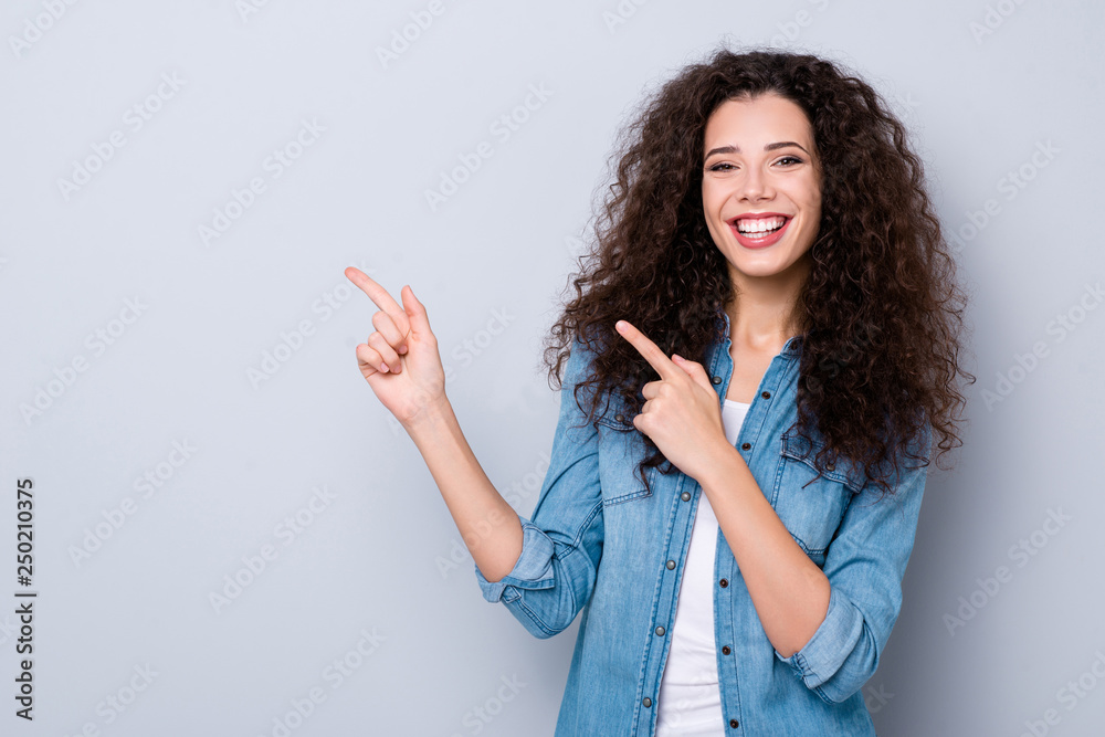 Portrait of her she nice cute pretty charming attractive lovely cheerful cheery positive glad wavy-haired girl pointing two forefingers aside ad advert promotion isolated over gray pastel background