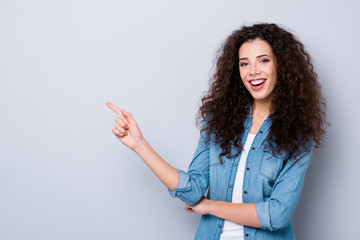 Portrait of her she nice cute pretty charming winsome attractive lovely cheerful cheery positive wavy-haired girl pointing forefinger aside ad promotion isolated over gray pastel background