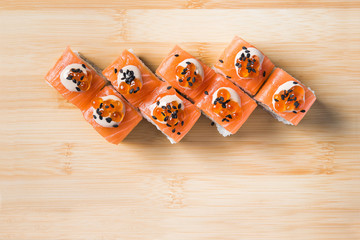 Wall Mural - Sushi rolls with caviar, mayonnaise and black sesame seeds