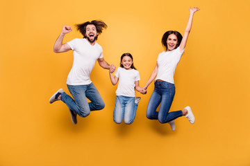 Poster - Full length body size portrait of nice lovely charming attractive positive cheerful people dad mom spending free time holding hands isolated over shine vivid pastel yellow background