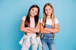 © deagreez - Portrait of nice-looking cute lovely sweet adorable well-groomed attractive cheerful cheery straight-haired brunette blonde girls siblings folded arms isolated over blue pastel background
