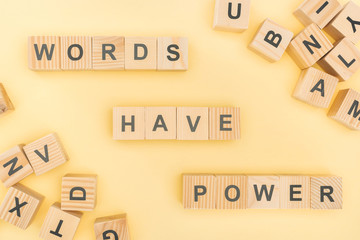 Wall Mural - top view of phrase words have power lettering with wooden cubes on yellow background