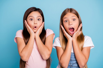 Canvas Print - Close-up portrait of two people nice cute attractive charming scared toothy straight-haired pre-teen girls showing omg expression scary news isolated over blue pastel background