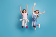 © deagreez - Full length body size view of two people attractive charming cheerful careless carefree straight-haired pre-teen girls having fun party overjoy great weekend day isolated on blue pastel background